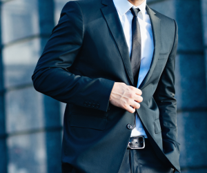 Man wearing matching black suit and tie with a white shirt